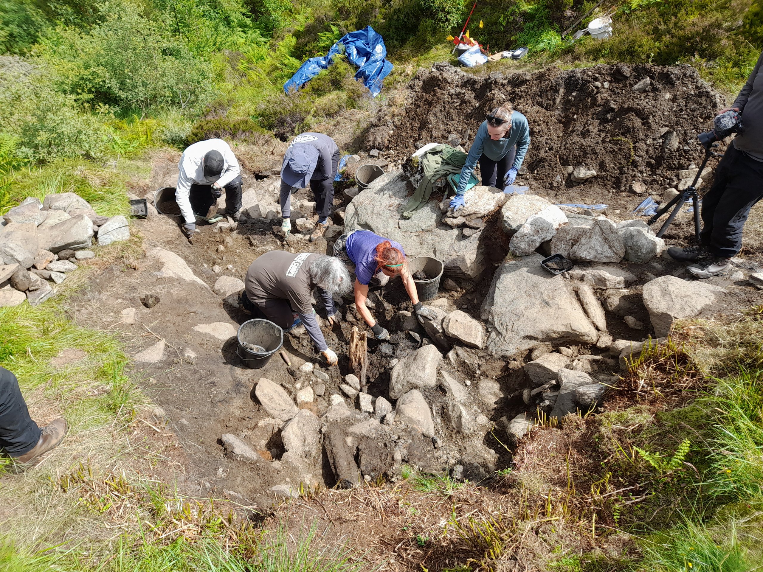 Archaeologists dig into a bothy site at Ben Lowers. Image courtesy National Trust for Scotland.
