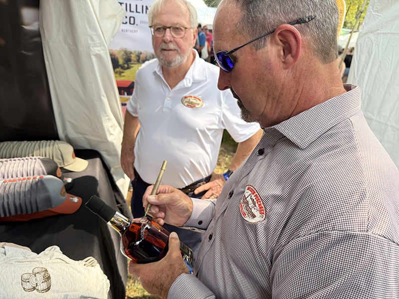 Jackson Purchase master distiller Craig Beam signs a bottle during the Kentucky Bourbon Festival. ©2025, Mark Gillespie/CaskStrength Media.