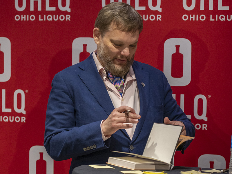 Fred Minnick signing a copy of "Bottom Shelf." Photo by Rob Wagner courtesy of Fred Minnick.